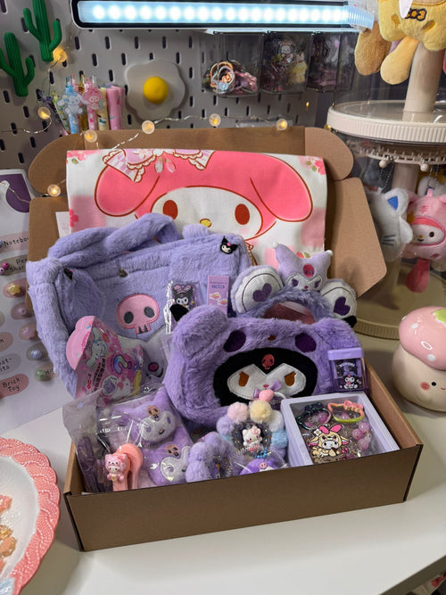 Box of Sanrio plush toys and accessories on a desk with a colorful background